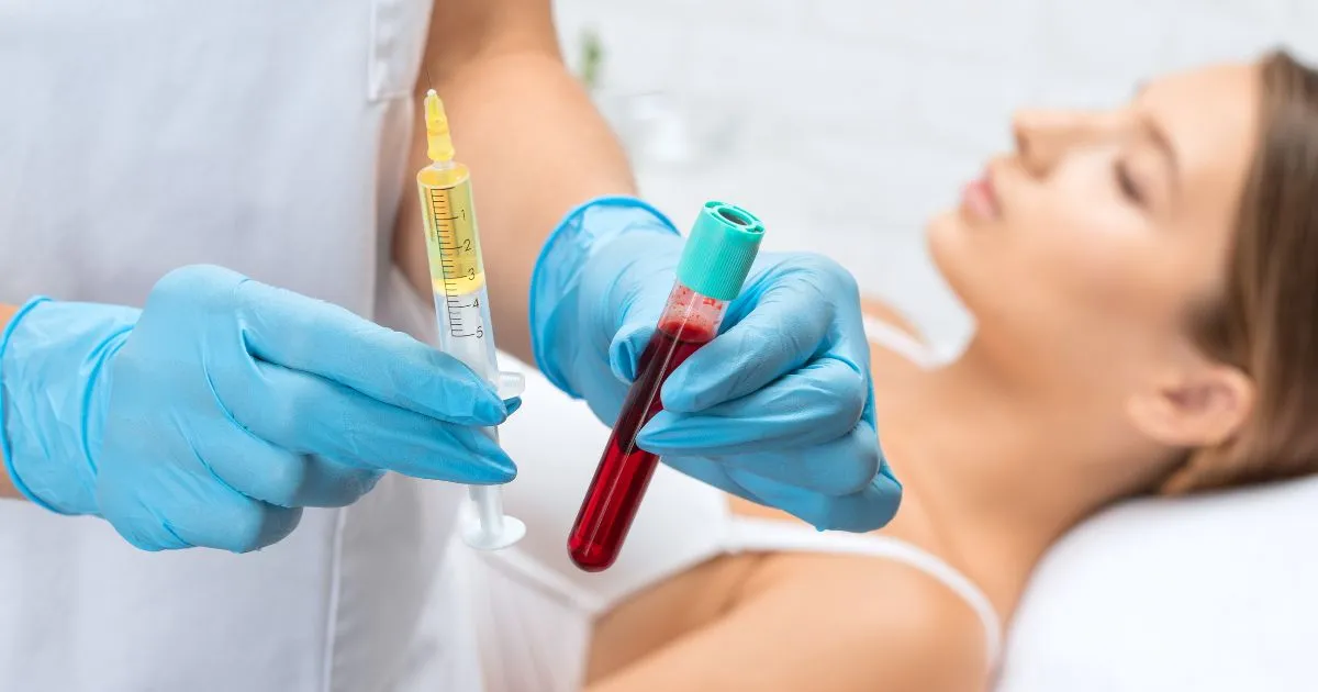 Healthcare professional holding a syringe and a blood tube for a PRP treatment in Woodinville, WA